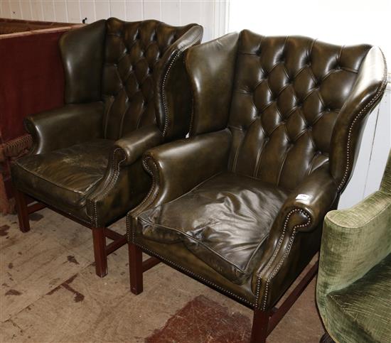 Pair of brown leather buttoned wing armchairs
